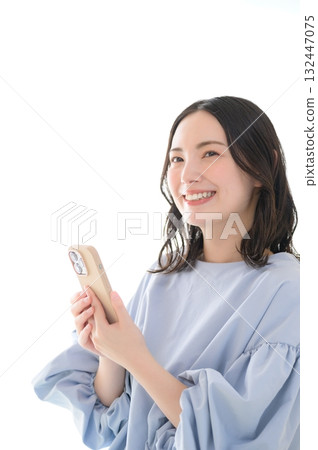 A worried Japanese woman looking at her smartphone A worried Japanese woman looking at her smartphone 132447075