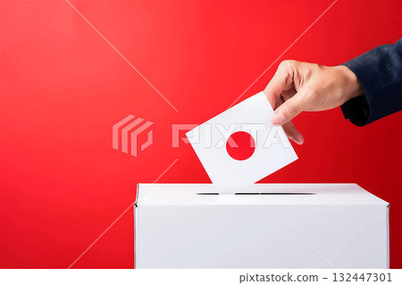 Hand putting a ballot into a ballot box 132447301