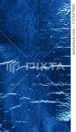 exture of shiny blue foil with numerous wrinkles and folds. Close up 132447800