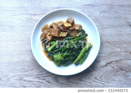 fried Kailaan Chinese kale and dice tofu dressing soy sauce vegetarian food on plate fried Kailaan Chinese kale and dice tofu dressing soy sauce vegetarian food on plate 132448573