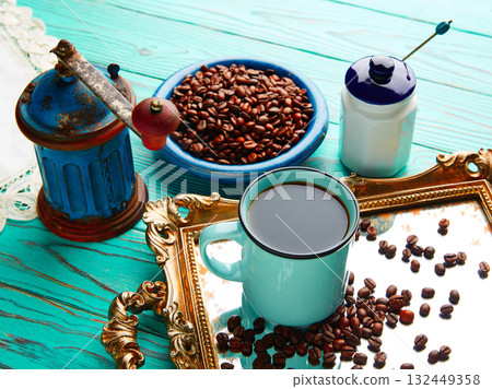 Coffee cup with vintage grinder on wood table 132449358