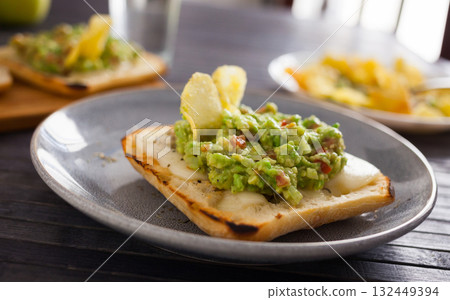morning toast with melted cheese and guacamol morning toast with melted cheese and guacamol 132449394