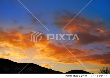 Sunset mountain silhouette with orange clouds 132449463