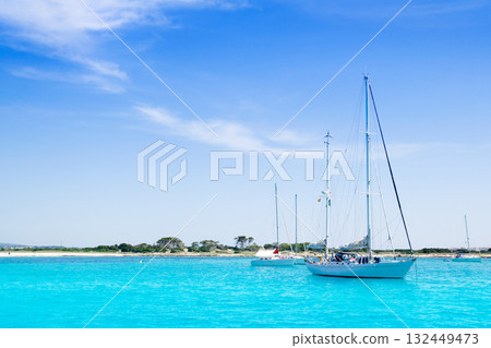 anchored sailboats in turquoise Formentera beach anchored sailboats in turquoise Formentera beach 132449473