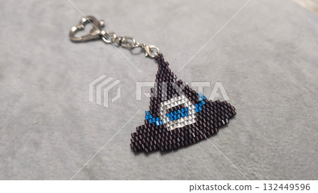 A cartoon character-shaped keychain, handcrafted from multicolored seed beads A cartoon character-shaped keychain, handcrafted from multicolored seed beads 132449596