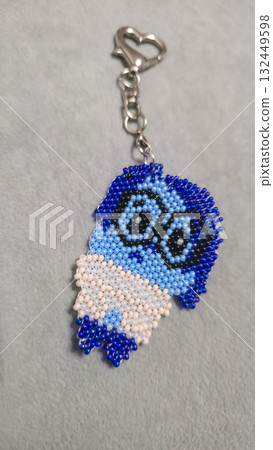 A cartoon character-shaped keychain, handcrafted from multicolored seed beads A cartoon character-shaped keychain, handcrafted from multicolored seed beads 132449598