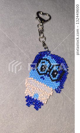 A cartoon character-shaped keychain, handcrafted from multicolored seed beads A cartoon character-shaped keychain, handcrafted from multicolored seed beads 132449600