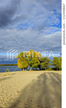 An autumn river landscape with yellow leaves on the trees, reflections 132449667