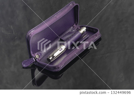 A signature fountain pen on a gray marble background. A box and case are nearby. 132449696