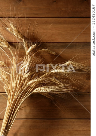 Ear golden wheat spike over wooden background 132450167
