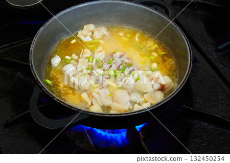 Seafood paella cooking process with squid Seafood paella cooking process with squid 132450254