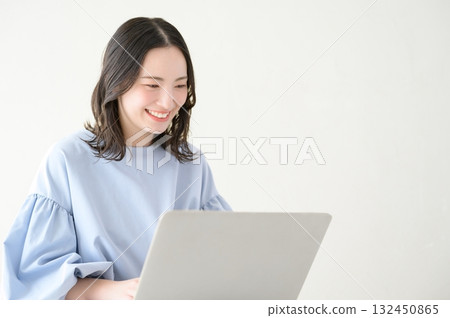 A Japanese woman operating a personal computer 132450865