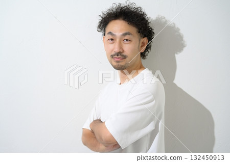 A man with his arms crossed on a white background A man with his arms crossed on a white background 132450913