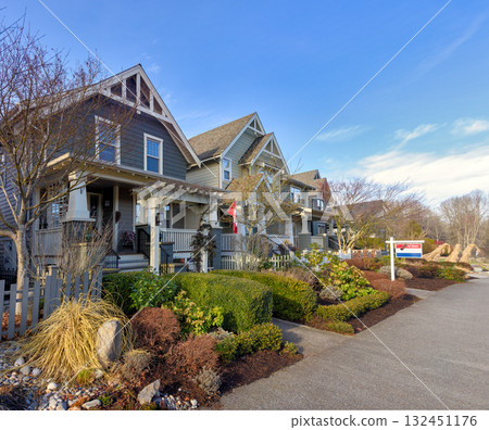 Row of residential houses with one house for sale on winter season in Canada Row of residential houses with one house for sale on winter season in Canada 132451176