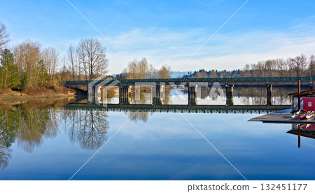 A beautiful river landscape with a white church on the shore 132451177