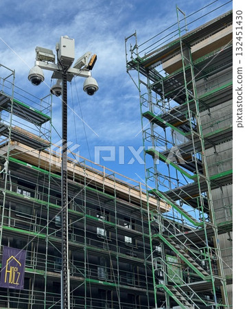 Building under construction with scaffolding and a sign that says Fire 132451430