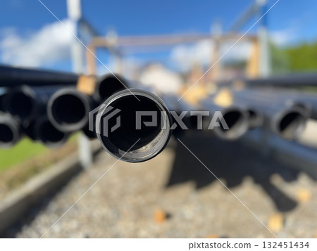 Bunch of pipes are stacked up in a pile 132451434