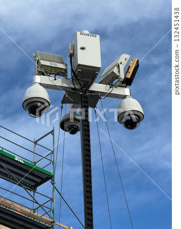 Tall pole with three cameras on it 132451438