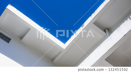 Minimal architecture of modern white building with geometric lines and blue sky background 132451592