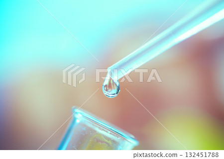 A drop of liquid drips from a pipette into a chemical tube A drop of liquid drips from a pipette into a chemical tube 132451788
