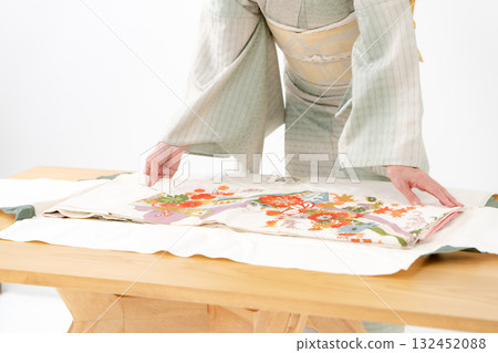Woman folding kimono, recycling, hands 132452088