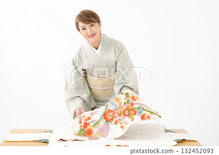 Woman folding kimono recycling 132452093