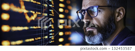 Focused Professional Analyzing Stock Market Trends on Digital Screen with Graphs 132453587