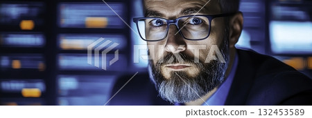 Focused Male Professional with Glasses Working in Modern Digital Environment 132453589