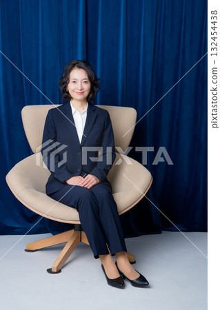 Middle-aged businesswoman sitting on a large chair 132454438