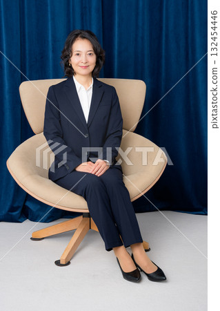 Middle-aged businesswoman sitting on a large chair 132454446