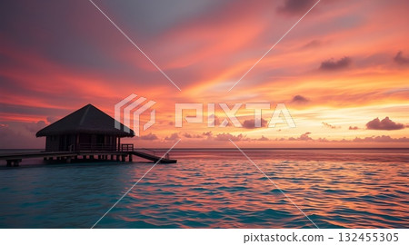 Sunset on a tropical beach with pier and ocean view at dusk. 132455305