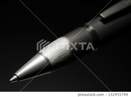 Dramatic close up of a charcoal grey rollerball pen with brushed metal finish 132455749