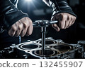 Mechanic hands tightening engine bolts with a ratchet wrench during automotive repair 132455907