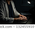 Dedicated medical professional typing on computer keyboard during late night shift 132455910