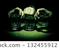 Three hands holding glasses of water in a dark, suspenseful, high contrast scene 132455912