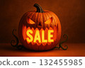 Carved pumpkin with sinister expression, glowing orange letters spelling SALE inside, set against warm, dark background. scene evokes festive 132455985