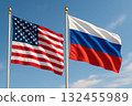 United States and Russia flags waving in wind against clear blue sky, symbolizing international relations and diplomacy 132455989