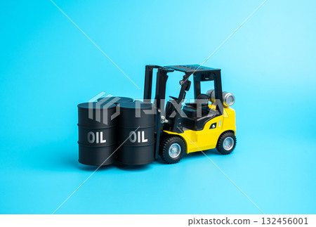 A loader with oil barrels. Oil storage and logistics. Fuel storage facilities. Fuel for industry. Petroleum trade, and energy supply management. Energy markets, global fuel economy 132456001