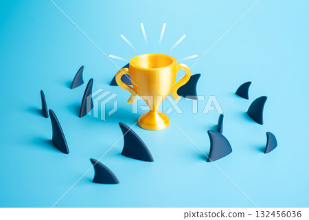 A winner's cup amidst a school of sharks. Dangers and pitfalls on the path to victory and success. Ambition, risk-taking, and survival in a competitive environment. Entrepreneurship, career motivation 132456036