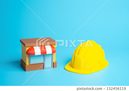 A business store and a yellow construction helmet. Build your own business. Entrepreneurship, small enterprise creation, and strategic growth in modern markets. 132456119