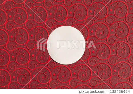 White circle on red swirl patterned background with glitter accents 132456464