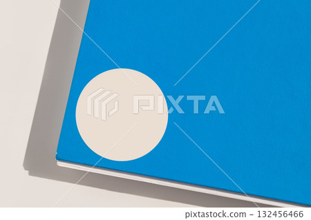 Blue book cover with white circle design on minimal background Blue book cover with white circle design on minimal background 132456466