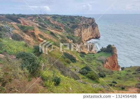 Rugged coastal landscape with cliffs and ocean in algarve, portugal Rugged coastal landscape with cliffs and ocean in algarve, portugal 132456486