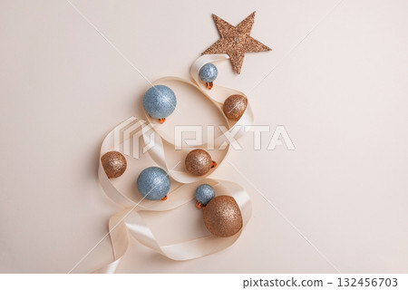Minimalist Christmas Tree Made of Ribbon and Ornaments on Light Background Minimalist Christmas Tree Made of Ribbon and Ornaments on Light Background 132456703