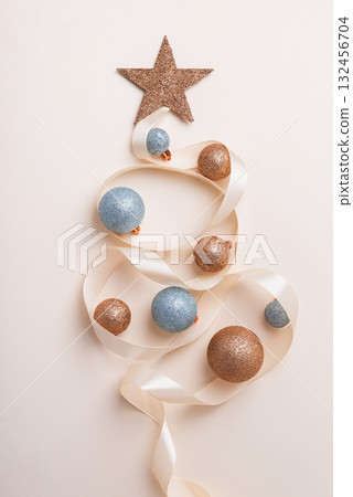 Minimalist Christmas Tree Made of Ribbon and Ornaments on Light Background Minimalist Christmas Tree Made of Ribbon and Ornaments on Light Background 132456704