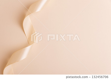Elegant Satin Ribbon on Beige Background for Festive Design 132456706