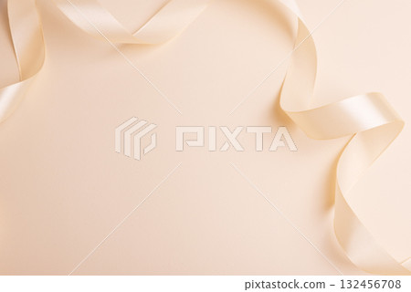 Elegant Satin Ribbon on Beige Background for Festive Design 132456708
