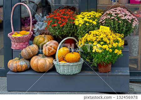 Pumpkins and flowers on street market 132456978