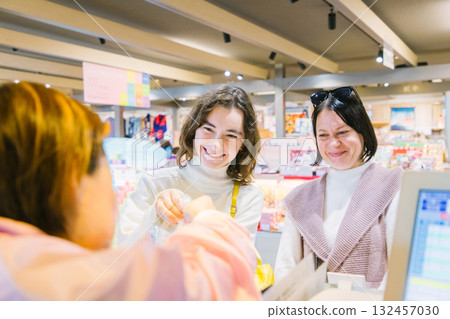Foreign tourists paying at the cash register 132457030