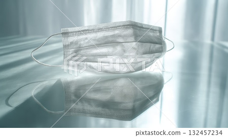Disposable Medical Face Mask On Reflective Surface For Health Care And Safety Imagery 132457234